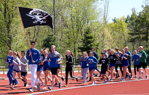 Bedford Track team carrying swag flag